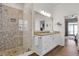 Bright bathroom features a modern vanity with granite countertop and a glass enclosed shower with unique stone tile at 212 Ocean Blvd, Isle of Palms, SC 29451