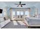 Light-filled bedroom with light blue walls, opening onto a balcony with picturesque ocean views at 212 Ocean Blvd, Isle of Palms, SC 29451