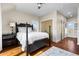 Cozy bedroom featuring wood floors, a dark wood bed, and ample natural light at 212 Ocean Blvd, Isle of Palms, SC 29451
