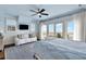 Comfortable bedroom features light blue walls, balcony access, and a cozy sitting area at 212 Ocean Blvd, Isle of Palms, SC 29451