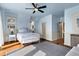 Bright bedroom with charming blue accents, hardwood floors, and abundant natural light at 212 Ocean Blvd, Isle of Palms, SC 29451