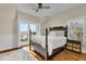 Bright bedroom with dark furniture, a ceiling fan, and access to a balcony with ocean views at 212 Ocean Blvd, Isle of Palms, SC 29451