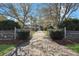 Inviting driveway leading to a charming home, framed by lush trees and greenery at 212 Ocean Blvd, Isle of Palms, SC 29451