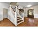Bright foyer featuring hardwood floors and staircase with detailed lattice design at 212 Ocean Blvd, Isle of Palms, SC 29451