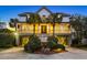 Charming two-story home with a inviting porch, well-manicured landscaping, and ample curb appeal at 212 Ocean Blvd, Isle of Palms, SC 29451