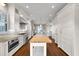 Spacious kitchen featuring ample white cabinetry, stainless steel appliances, a butcher block island, and hardwood flooring at 212 Ocean Blvd, Isle of Palms, SC 29451