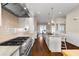 Modern kitchen with stainless steel appliances, granite countertops, an island with seating, and a view of the water at 212 Ocean Blvd, Isle of Palms, SC 29451