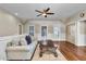 Bright living room with hardwood floors, a comfy sofa, and scenic views from the windows at 212 Ocean Blvd, Isle of Palms, SC 29451