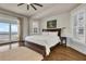 Serene bedroom with a king bed, hardwood floors, an ocean view, and access to a balcony at 212 Ocean Blvd, Isle of Palms, SC 29451