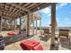 Outdoor patio featuring cornhole, lounge chairs, and stairs to the upper level under a raised home at 212 Ocean Blvd, Isle of Palms, SC 29451