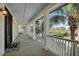 Inviting covered porch with wooden floors and white railings, perfect for relaxing and enjoying the view at 212 Ocean Blvd, Isle of Palms, SC 29451