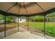 Backyard view features a storage shed on a lush green lawn, a wooded perimeter, and a concrete patio at 218 Candleberry Cir, Goose Creek, SC 29445