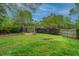 Lush backyard featuring a pergola fire pit, a wooden fence, and landscaped garden beds with mature trees at 218 Candleberry Cir, Goose Creek, SC 29445