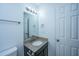 Well-lit bathroom featuring a vanity with a granite countertop, a large mirror, and white walls at 218 Candleberry Cir, Goose Creek, SC 29445