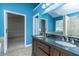 The bathroom features a double vanity sink, bright blue walls, and easy access to the bedroom and closet at 218 Candleberry Cir, Goose Creek, SC 29445