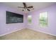 Spacious bedroom with a ceiling fan, two windows, carpet, and a chalkboard at 218 Candleberry Cir, Goose Creek, SC 29445
