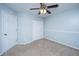 Bedroom featuring light blue walls, carpet, a ceiling fan, a door and a closet at 218 Candleberry Cir, Goose Creek, SC 29445