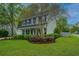 Charming two-story home boasts a well-manicured lawn and inviting front porch at 218 Candleberry Cir, Goose Creek, SC 29445