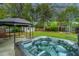 Outdoor space with hot tub and covered pergola, perfect for backyard entertaining at 218 Candleberry Cir, Goose Creek, SC 29445