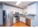 Updated kitchen with granite countertops, stainless steel appliances, and white cabinetry offers both style and functionality at 218 Candleberry Cir, Goose Creek, SC 29445