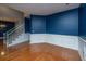 Elegant living room with hardwood floors, staircase and wainscoting, offering a sophisticated yet welcoming atmosphere at 218 Candleberry Cir, Goose Creek, SC 29445