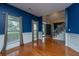 The entry of this living room features hardwood floors, bright windows, and blue accent walls at 218 Candleberry Cir, Goose Creek, SC 29445