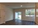 Cozy bedroom with hardwood floors, a window with a view, and a sliding glass door at 2405 Scarlett Maple St, Summerville, SC 29486