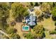 Stunning aerial shot of a home with a pool surrounded by lush greenery and a circular driveway at 2410 Kemway Rd, Johns Island, SC 29455