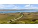 Picturesque aerial view of a waterway with a long winding road and private docks at 2410 Kemway Rd, Johns Island, SC 29455