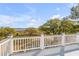Scenic backyard view from the balcony, featuring trees and serene marshland under a bright, partly cloudy sky at 2410 Kemway Rd, Johns Island, SC 29455