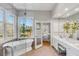 Bright bathroom featuring a tub, shower, double sink vanity, and outside views at 2410 Kemway Rd, Johns Island, SC 29455