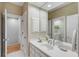 Bathroom featuring white vanity with storage, a large mirror, white walls, and tiled floors at 2410 Kemway Rd, Johns Island, SC 29455