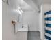 Bright bathroom with white vanity, mirror, and blue-striped shower curtain at 2410 Kemway Rd, Johns Island, SC 29455