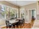 Bright dining room with large windows, wood floors, and a modern chandelier at 2410 Kemway Rd, Johns Island, SC 29455