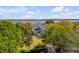 Picturesque home boasts serene waterfront views, beautifully framed by lush trees and mature landscaping at 2410 Kemway Rd, Johns Island, SC 29455