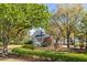 Charming two-story home features a manicured front yard with lush landscaping and mature trees at 2410 Kemway Rd, Johns Island, SC 29455