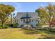 Charming two-story home with a symmetrical facade, manicured lawn, and lush landscaping creating a welcoming curb appeal at 2410 Kemway Rd, Johns Island, SC 29455