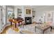 Living room featuring a fireplace, piano, hardwood flooring and shelves at 2410 Kemway Rd, Johns Island, SC 29455