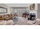 Bright living room featuring a fireplace, piano, and French doors to a porch at 2410 Kemway Rd, Johns Island, SC 29455