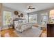 Serene main bedroom with natural light, neutral colors, hardwood floors, and an outdoor view at 2410 Kemway Rd, Johns Island, SC 29455