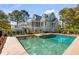 Gorgeous pool with adjacent lounge seating and a lush backyard at 2410 Kemway Rd, Johns Island, SC 29455
