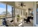 Spacious screened-in porch with ceiling fans, comfortable seating, and waterfront views at 2410 Kemway Rd, Johns Island, SC 29455
