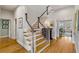 Elegant staircase with hardwood treads and white risers, illuminated by natural light at 2410 Kemway Rd, Johns Island, SC 29455