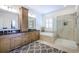 Bathroom featuring double vanity, a soaking tub, and separate glass-enclosed shower at 2447 Louisville St, Charleston, SC 29492