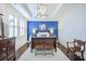 Charming bedroom boasts a dark wood bed frame with a blue accent wall and tray ceiling at 2447 Louisville St, Charleston, SC 29492