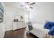 Clean bedroom featuring wood floors, ceiling fan and large dresser with bright natural light at 2447 Louisville St, Charleston, SC 29492