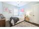 Well-lit bedroom features hardwood floors, a decorative rug, and light blue painted walls at 2447 Louisville St, Charleston, SC 29492