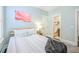 Bright bedroom featuring hardwood floors, cozy bedding, light blue walls, and bright natural light at 2447 Louisville St, Charleston, SC 29492