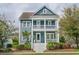 Inviting two-story home boasts a charming porch, fresh landscaping, and a welcoming facade at 2447 Louisville St, Charleston, SC 29492