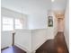 Bright hallway with beautiful dark hardwood floors, a modern light fixture, and white walls at 2447 Louisville St, Charleston, SC 29492